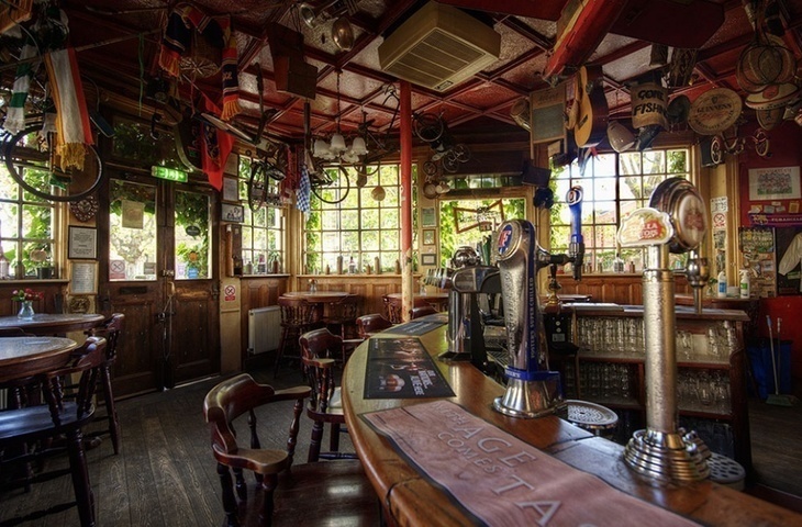 An old pub with various gimcrack including bikes hanging from the ceiling