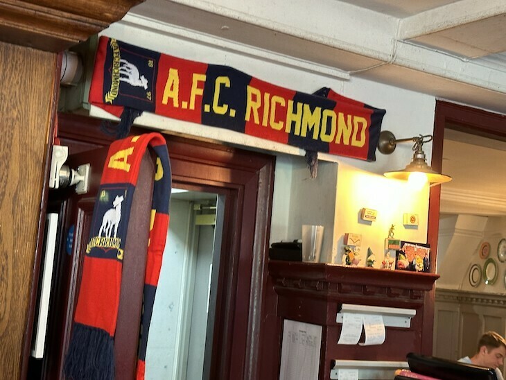 An AFC Richmond scarf above a doorway in a pub, the Princes Head